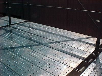 Non slip platforms made of traction-grip safety gratings are used in building constructions.
