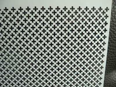 A piece of perforated metal ceiling with cross holes.