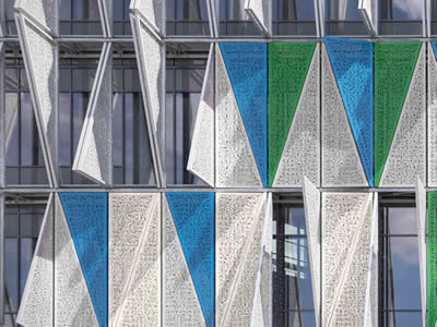 Many triangle perforated metal mesh plates with different colors are installed on windows.