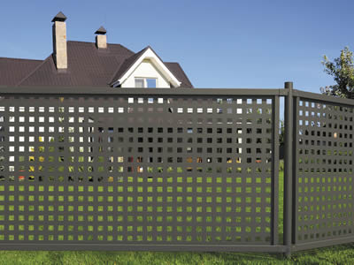 Perforated metal fences with square holes in straight rows surround villa as protection.